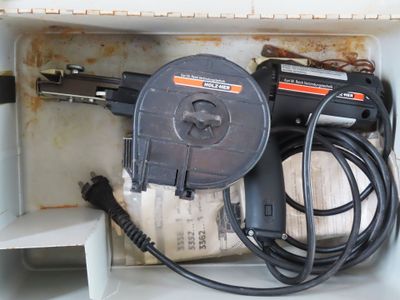 a box with a drill and a cord in it