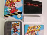 a nintendo game and a nintendo game on a table