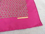 pink and gold square scarf with a gold medallion design on it