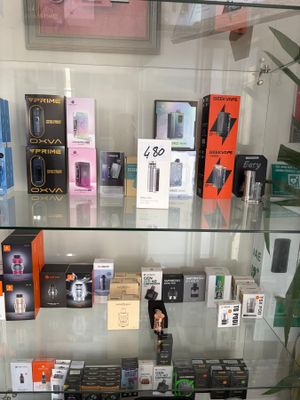 a glass display case filled with many different types of electronic devices