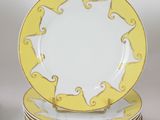 a stack of plates with yellow and white designs on them