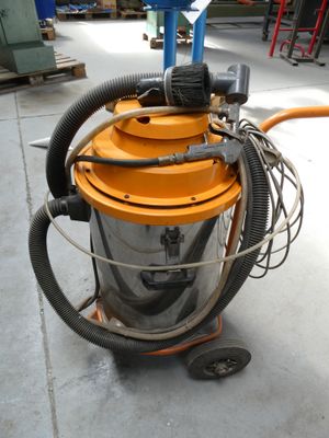 a machine that is sitting on the floor with a hose