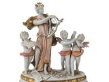 a figurine of a woman holding a harp and three cherensils