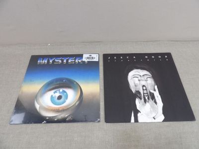 two posters of a woman with an eye and a man with an eyeball
