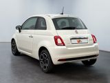 the back of a white fiat car parked in a white room