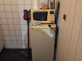 a small kitchen with a microwave on top of it