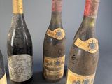 three bottles of wine are sitting next to each other on a table