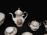 a lot of tea pots and cups that are on a table