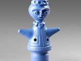 blue ceramic figurine of a woman with a hat on her head