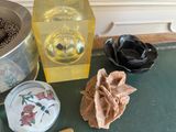 a glass container with a flower inside of it on a table
