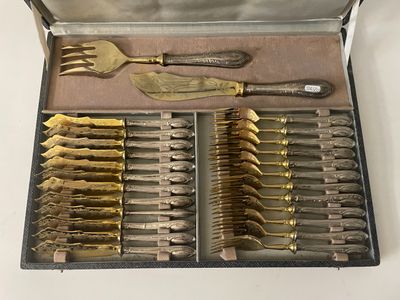 silverware in a case with knives and spoons on a table