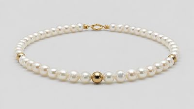 a white pearl bracelet with a gold clasp