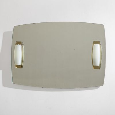 a mirror that is on the wall with two handles