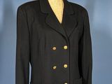 a black jacket with gold buttons is on a mannequin stand