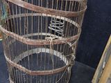 a bird in a cage that is sitting on the floor