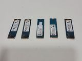 four memory modules are sitting on a white surface next to each other