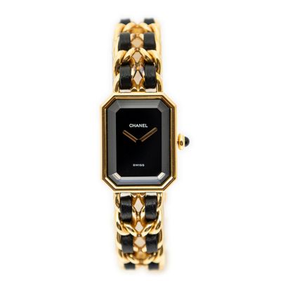 a close up of a black and gold watch on a white background