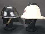 pair of black and white helmets on a black mannequin head