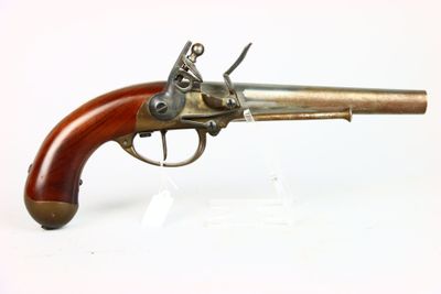 a close up of a gun with a wooden handle on a white surface