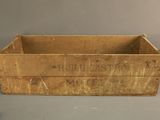 an old wooden box with a sign on it sitting on top of a table