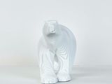 a white bear statue sitting on a white surface