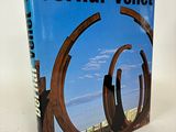 the book is sitting on a white surface with a blue sky in the background