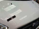 a close up of a white car with a sticker on it