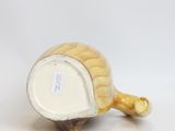 a small vase that has a gold decoration on it