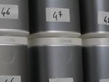six tins with numbers on them sitting on a shelf