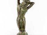 a statue of a woman holding her head in her hands