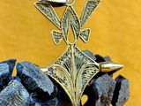 brass plated pendant with a bird on top of a pine cone