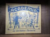 a sign on the wall that says academy la guitarra favorita