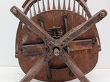 a wooden wheel with four spokes on top of it