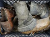 many pairs of old boots in a blue basket