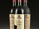 three bottles of wine are lined up on a table