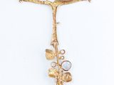 gold plated necklace with a flower and a bird on a branch