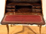a wooden desk with a red cloth on it