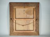 an old wooden picture frame with a picture hanging on the wall