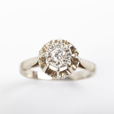 a close up of a diamond ring on a white background