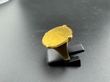 a gold ring sitting on top of a black table