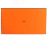 an orange box with a logo on it sitting on a white surface