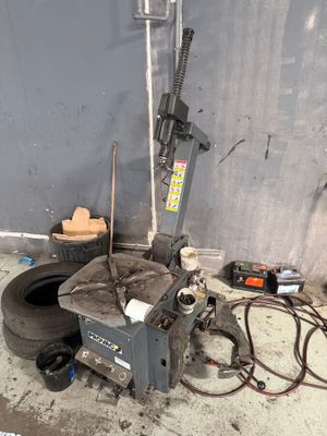 a machine that is sitting on the ground next to a tire