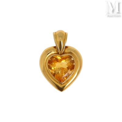 a close up of a yellow heart shaped pendant on a white background