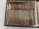 many spoons and spoons in a box on a table