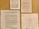 three papers are on a table with a pen and ink