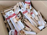 a cardboard box filled with wooden spoons and spatulas