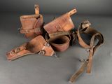 several pieces of leather are sitting on a gray surface