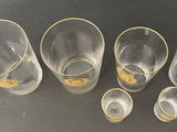 five empty glasses sitting on a table next to each other