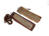 two pieces of leather and rope are laying on top of each other