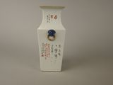 a white vase with a blue ring on it